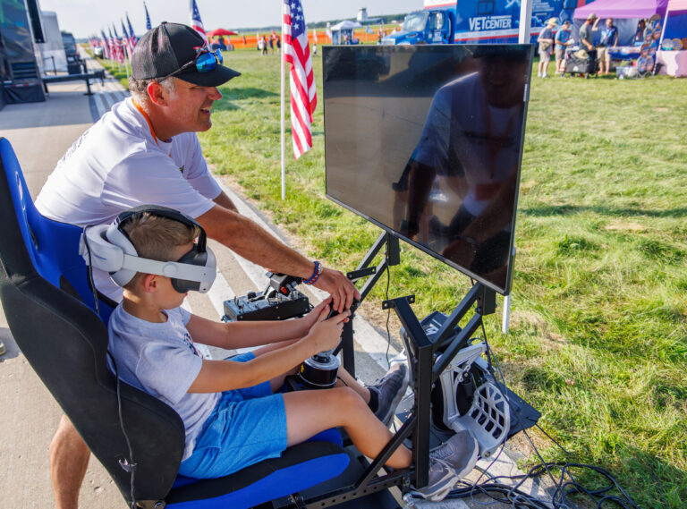 Patrick Mcalee teaching airshow fans about avaition Stem and aerobatics at an airshow